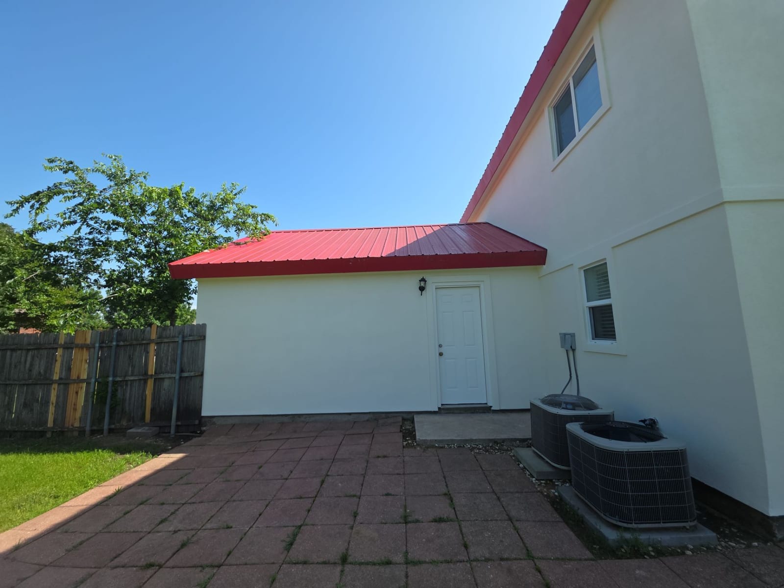 Backyard with brick paver patio and landscaping