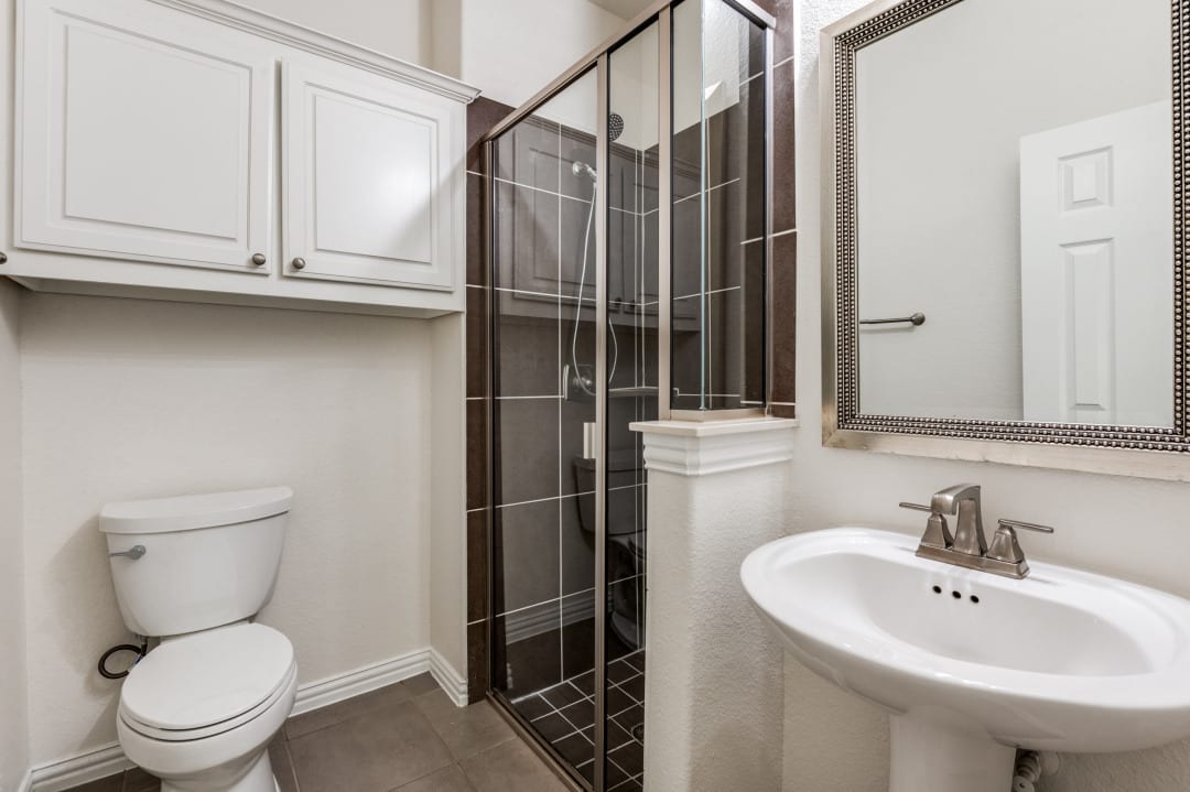 Updated bathroom with frameless glass shower enclosure