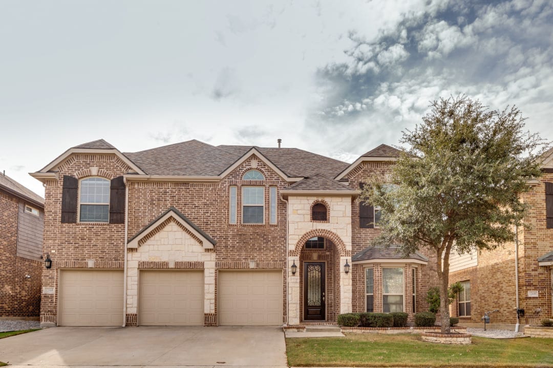 Two-story brick home exterior after a complete make-ready renovation