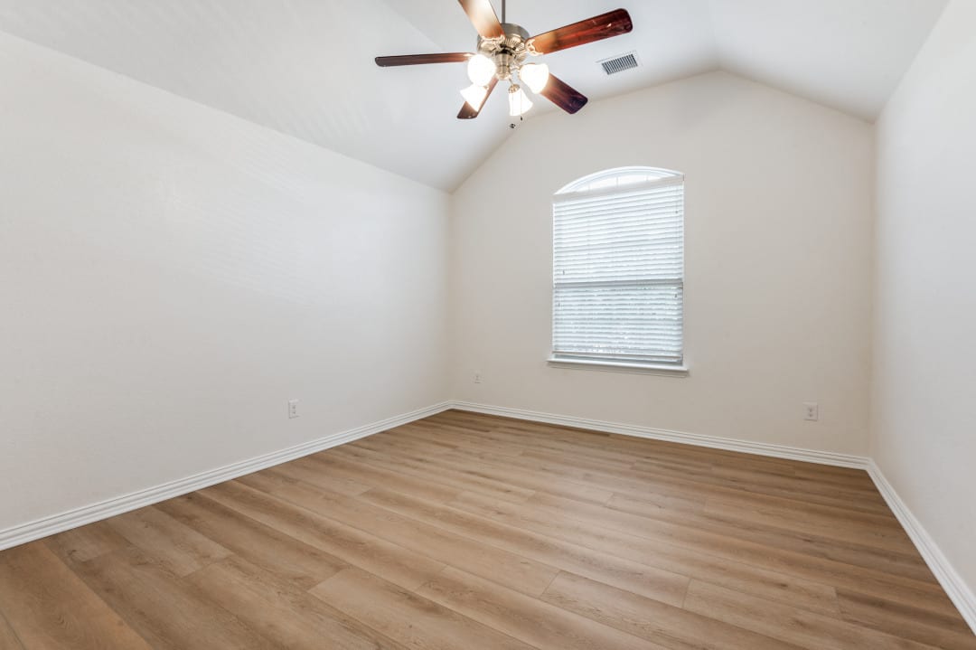 Freshly painted room with new wood-look flooring throughout