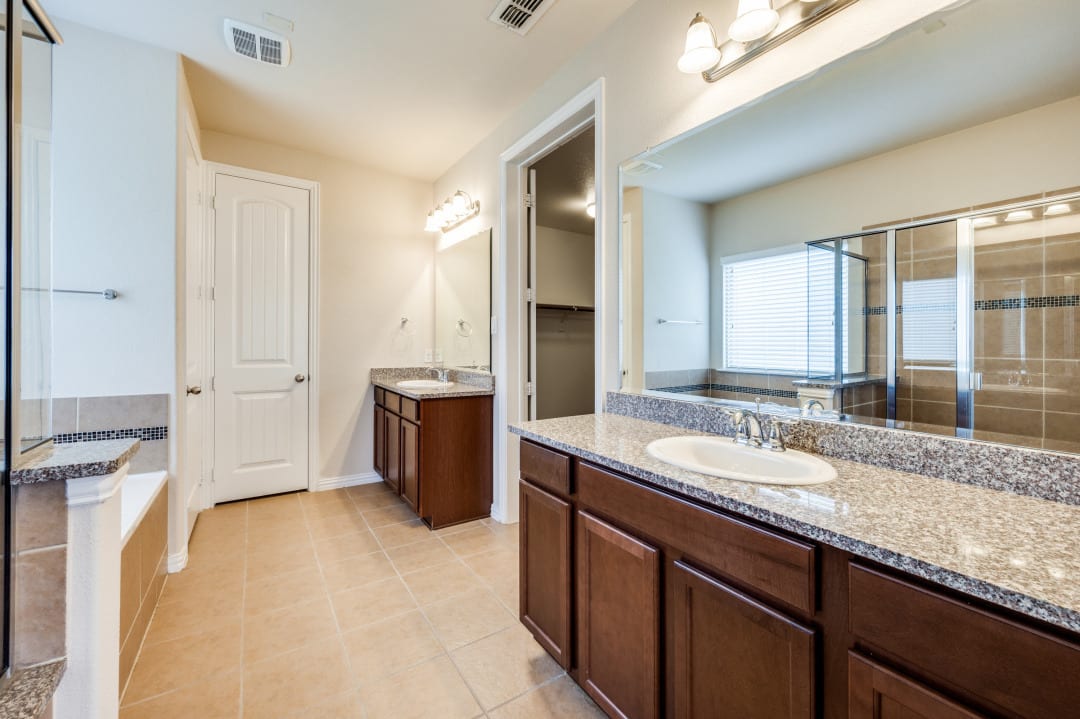 Dual-vanity bathroom with framed mirrors