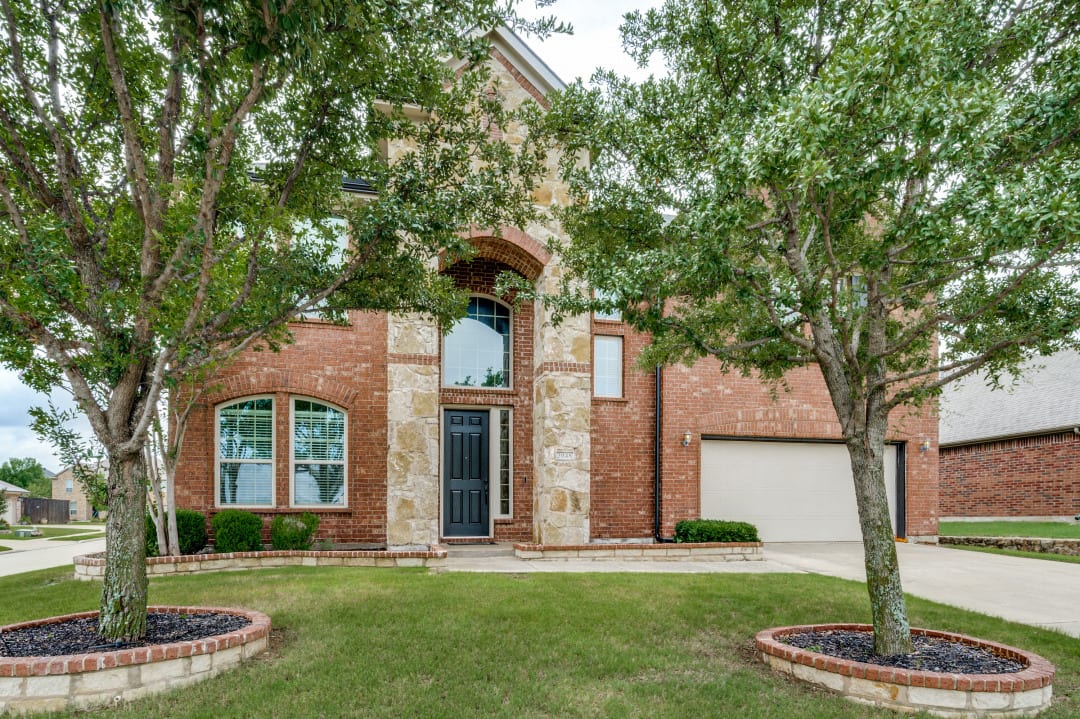 Brick two-story home exterior after a full interior and exterior refresh