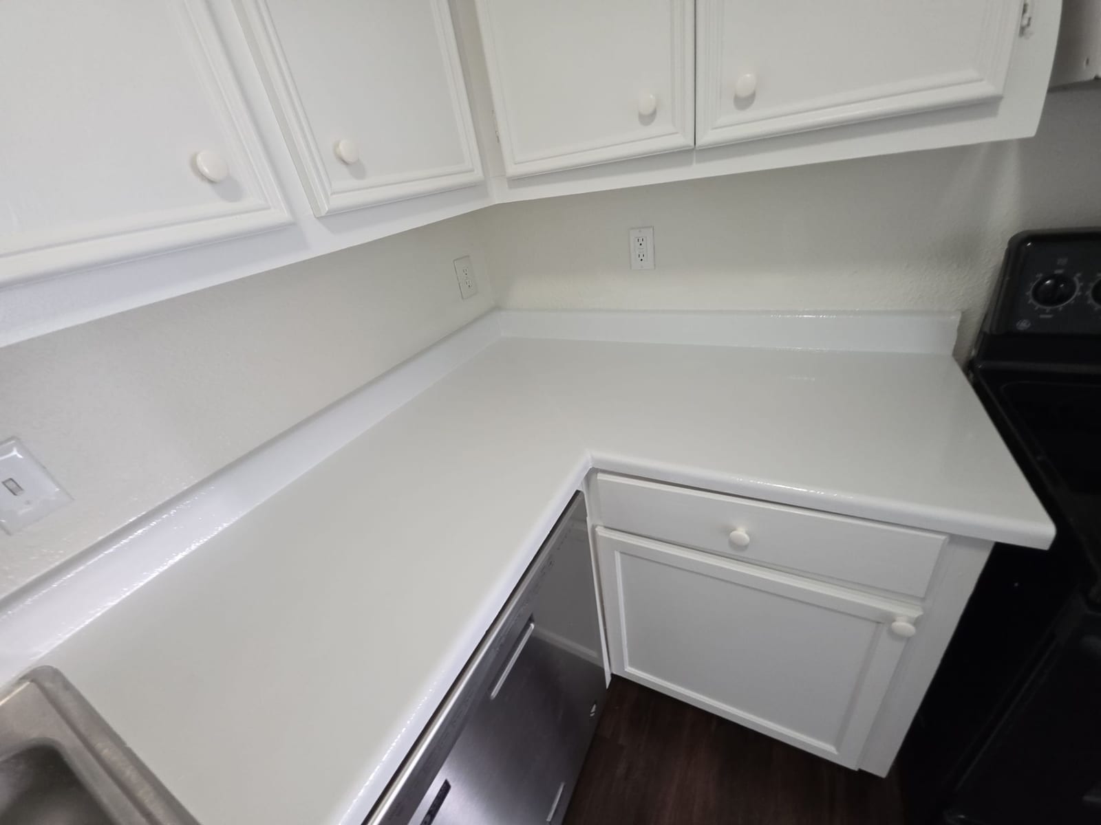 Refinished kitchen cabinetry with a fresh painted finish