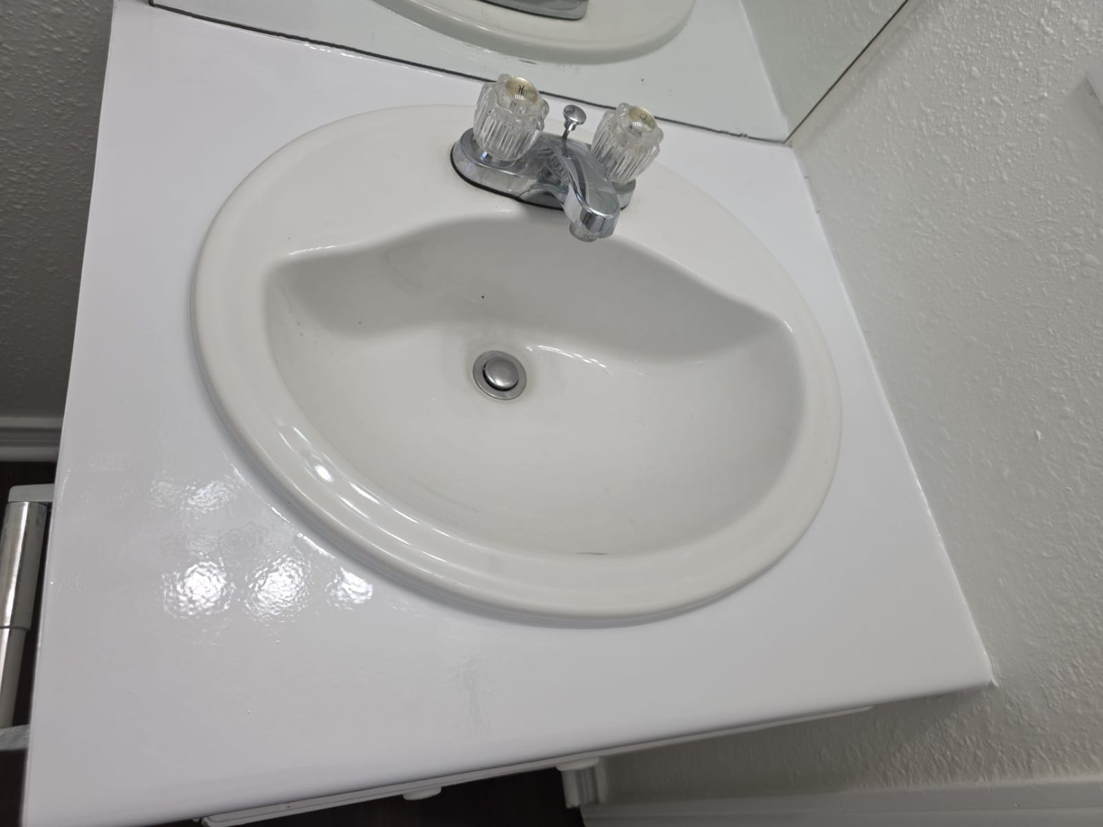 Refinished bathroom vanity repainted bright white
