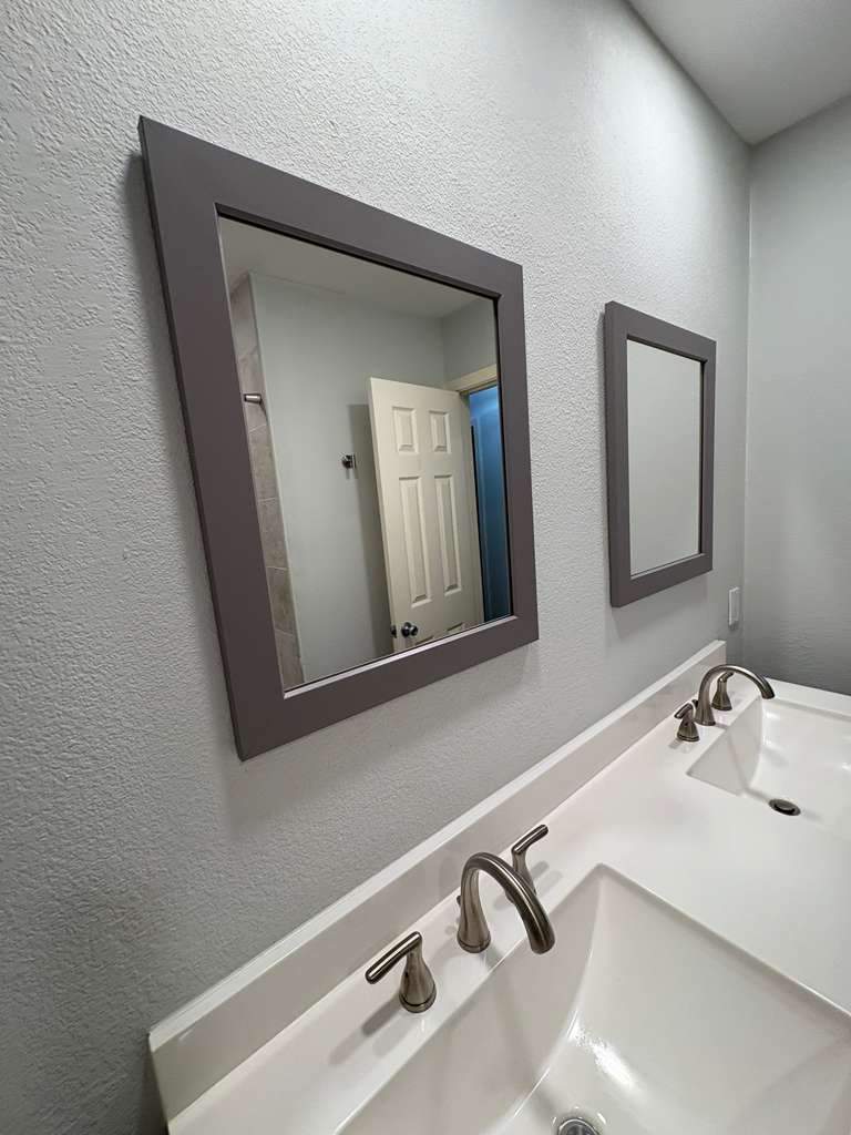 Dual-sink bathroom vanity renovation with framed mirrors