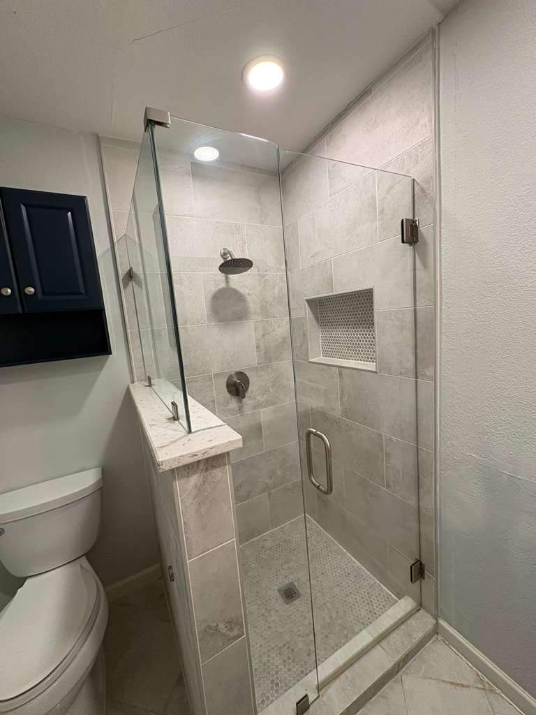 Bathroom renovation with frameless glass shower enclosure