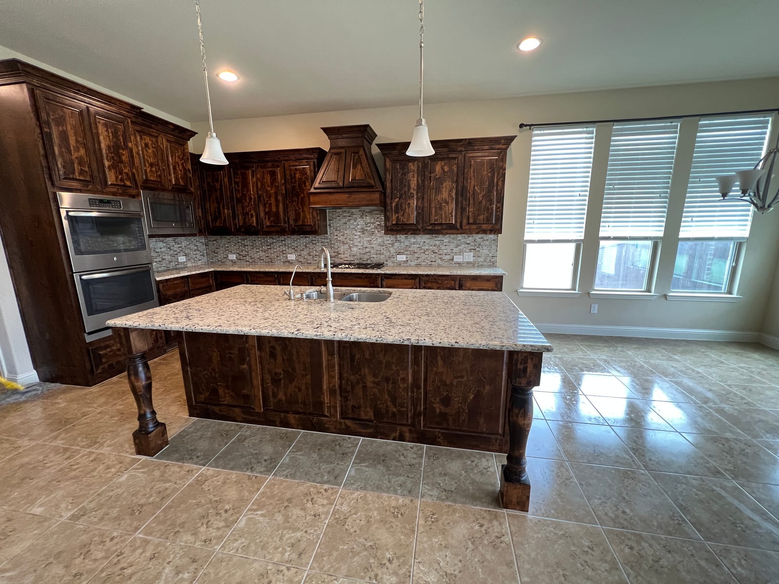 Renovated kitchen with dark cabinetry and center island